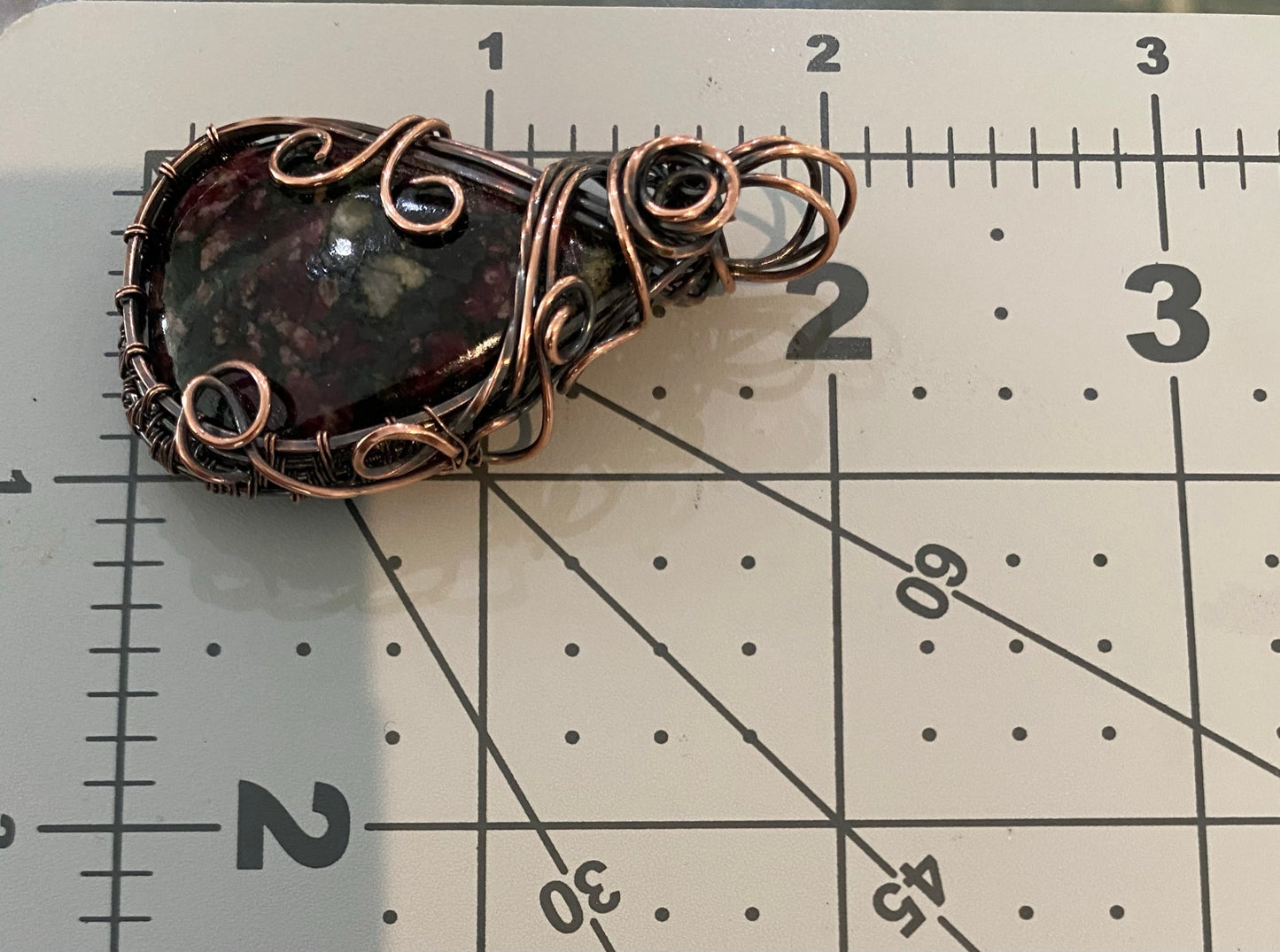 Eudialyte Teardrop Pendant Wrapped in Oxidized Copper Wire