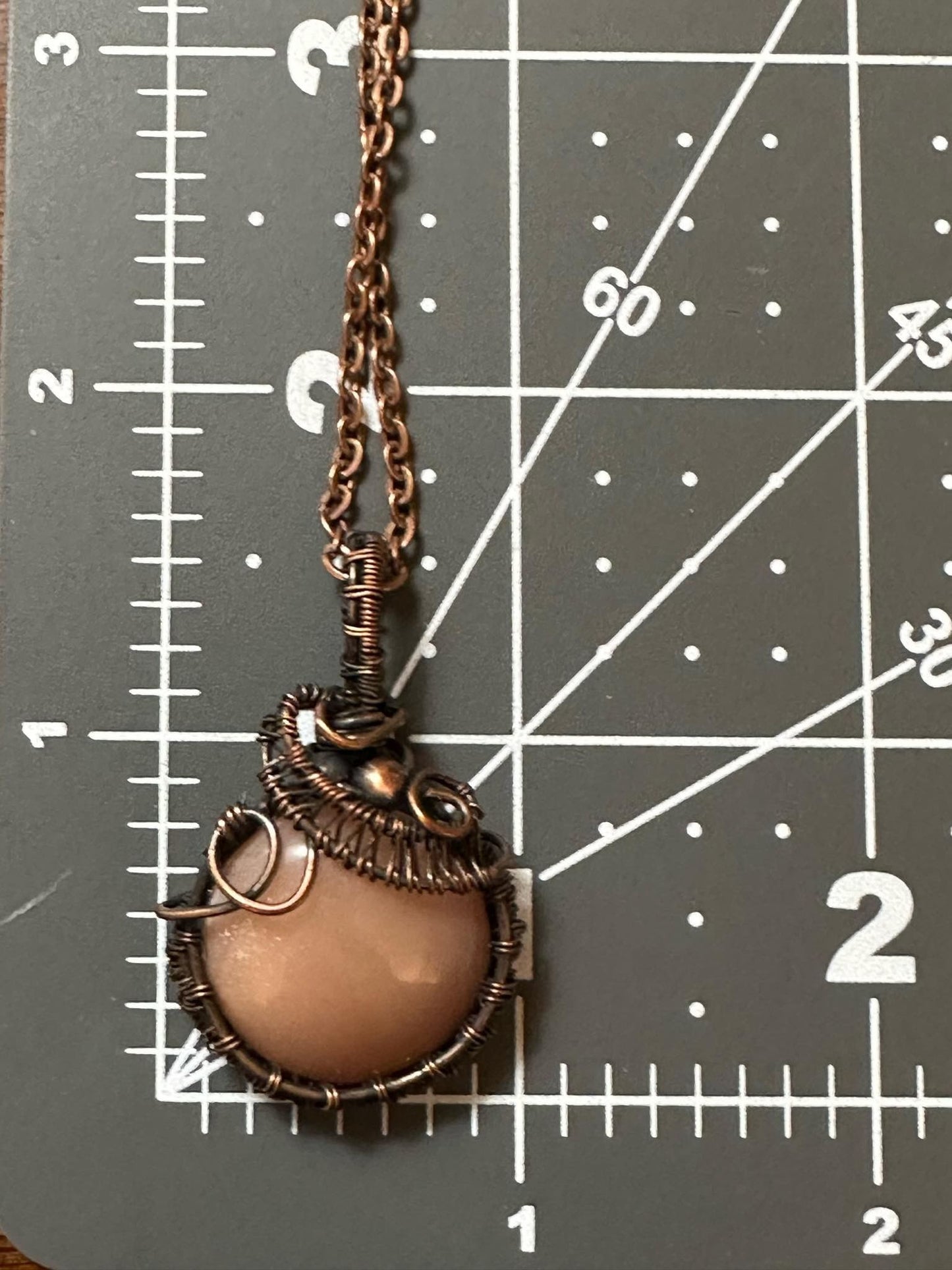 Round Peach Moonstone With Copper Bead And Wire Weaving Handmade Pendant